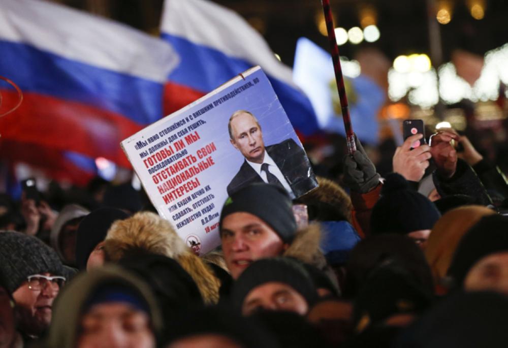 People attend a rally and concert marking the fourth anniversary of Russia's annexation of the Crimea region, at Manezhnaya Square in central Moscow, Russia Sunday. — Reuters