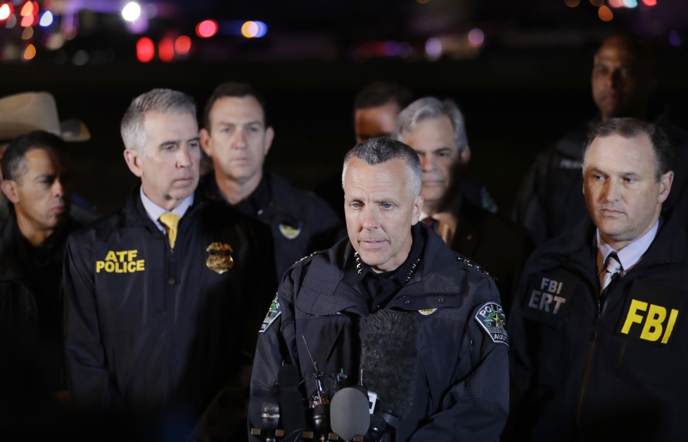 Austin Police Chief Brian Manley, center, stands with other members of law enforcement as he briefs the media in the Austin suburb of Round Rock, Texas, on Wednesday. — AP