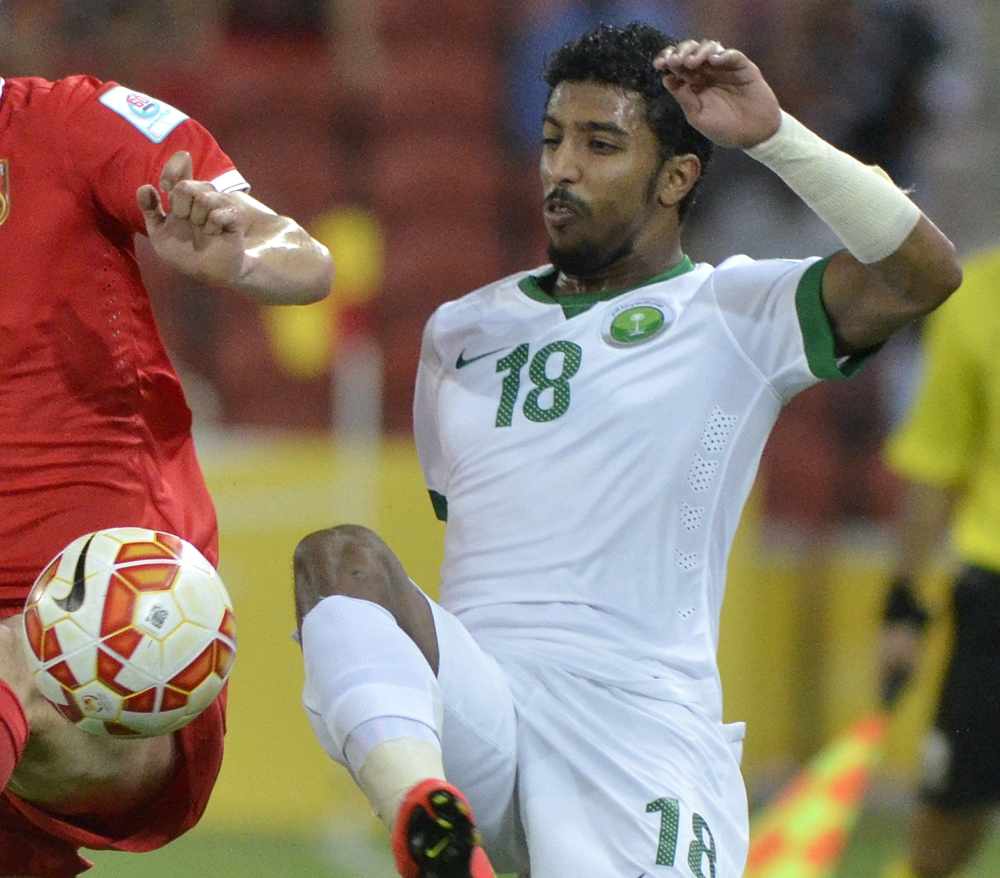 File photo shows Saudi Arabia's Salem Al-Dawsari battles for the ball during a first round soccer match against China at the AFC Asia Cup in Brisbane, Australia. — AP