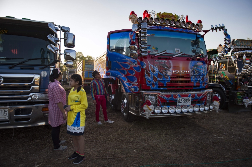 Rows of custom-decorated trucks are parked in a field at a fancy truck party in the Thai coastal province of Rayong in this Dec. 23, 2017 file photo. — AFP