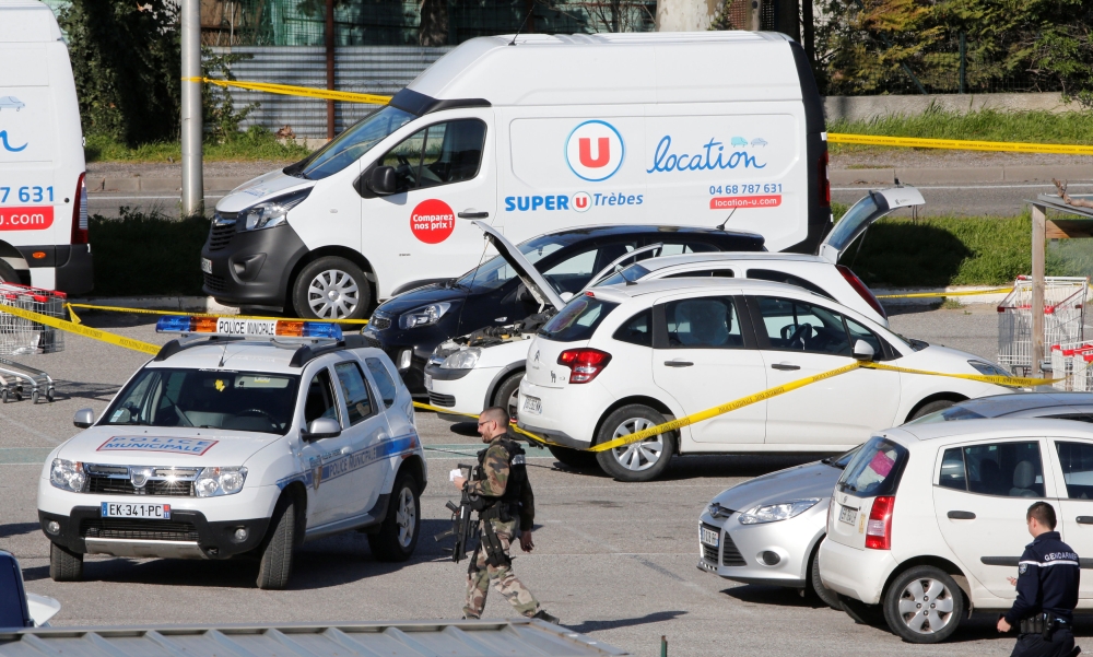 Police officers and investigators at a supermarket after a hostage situation in Trebes, France, on Friday. — Reuters