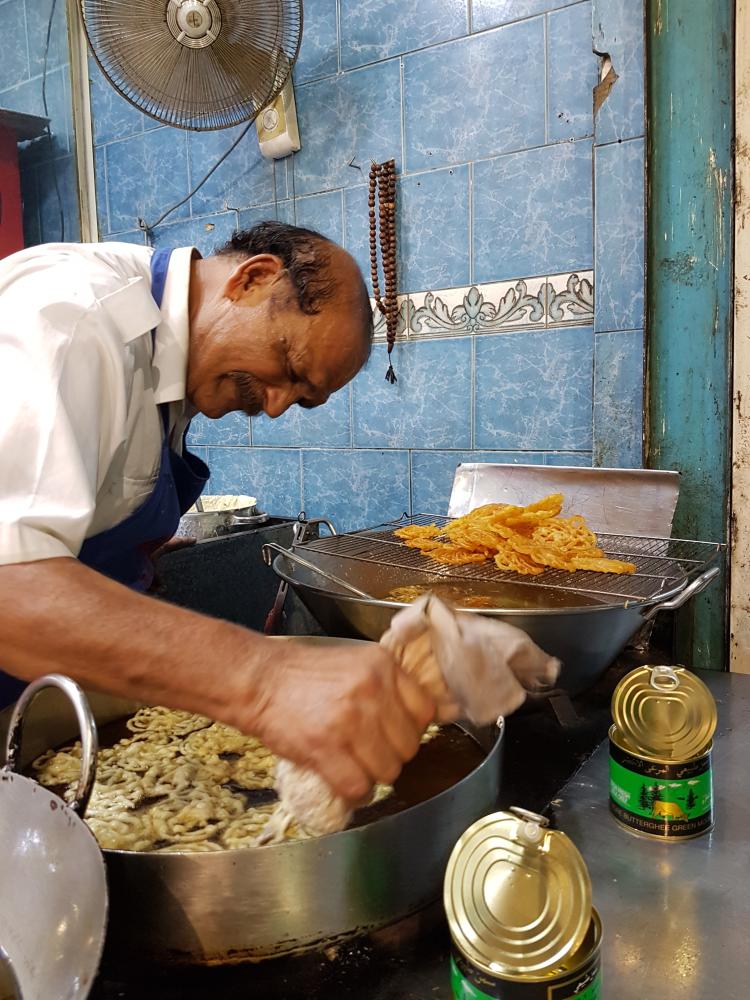 Jalebi, a popular sweet in south Asia, is being prepared by a sweet maker.