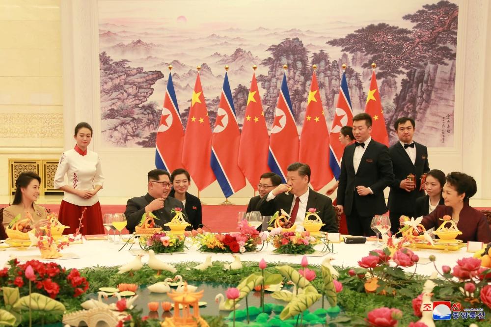 North Korean leader Kim Jong Un and wife Ri Sol Ju, and Chinese President Xi Jinping and wife Peng Liyuan toast each other, as Kim Jong Un paid an unofficial visit to Beijing, China, in this undated photo released by North Korea's Korean Central News Agency (KCNA) in Pyongyang March 28, 2018. — Reuters