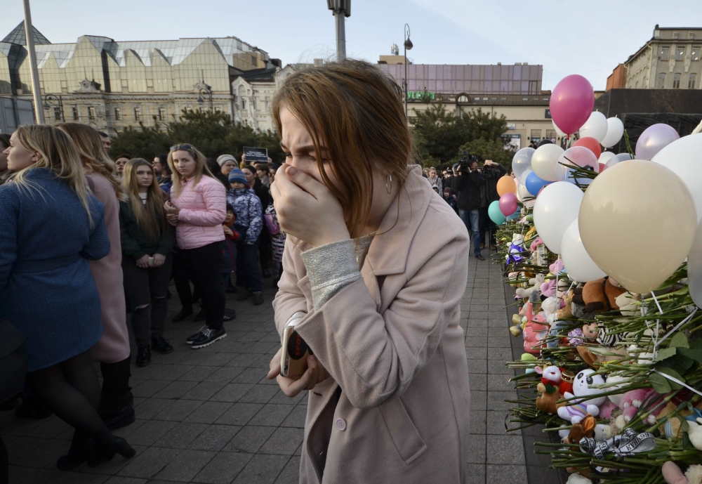 A woman reacts during a gathering to commemorate the victims of a shopping mall fire in Kemerovo on the day of national mourning in the far eastern city of Vladivostok, Russia, on Wednesday. — Reuters