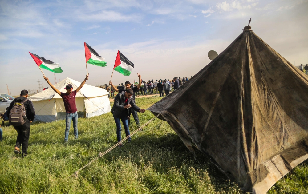 Palestinians set up tents near the Gaza-Israel border on the outskirts of Gaza City for a six-week show of support for Palestinian refugees. — AFP