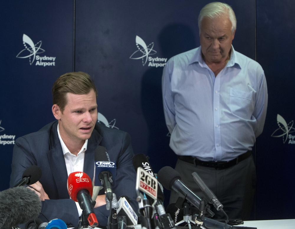Former Australian cricket captain Steve Smith speaks to the media while supported by his father, Peter, in Sydney, Thursday, after being sent home from South Africa following a ball tampering scandal. Smith and vice-captain David Warner were banned for 12 months while young batsman Cameron Bancroft received 9 months after an investigation into the Australian cricket team's cheating scandal identified Warner as the instigator of the ball tampering plan that unraveled in South Africa. — AP