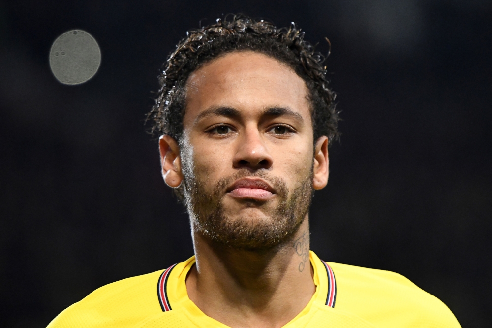 In this file photo, Paris Saint-Germain's Brazilian forward Neymar looks on during the French League Cup football semifinal match between Rennes and Paris Saint-Germain at the Roazhon Park stadium in Rennes. Neymar, recovering in Brazil after his right foot injury, will return 