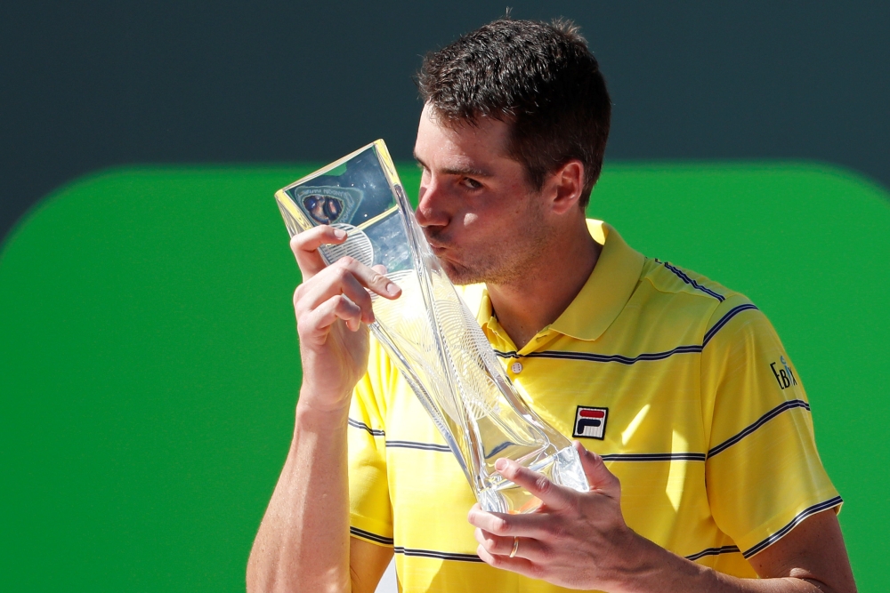 John Isner of the United States kisses the Butch Buchholz championship trophy after his match against Alexander Zverev of Germany (not pictured) in the men's singles final of the Miami Open at Tennis Center at Crandon Park. — Reuters
