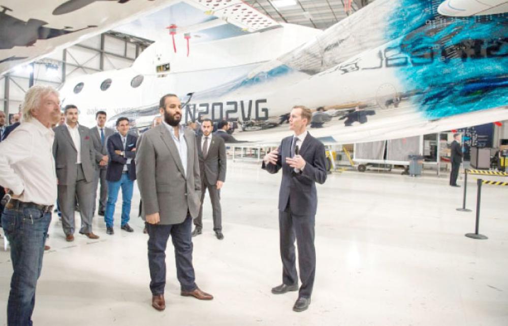 Crown Prince Muhammad Bin Salman, deputy premier and minister of defense, poses for a photo with Richard Branson, founder of Virgin Group and Chairman of the Board of Directors of Virgin Galactic, during a tour to the facility in Mojave in California early on Monday. — SPA photos