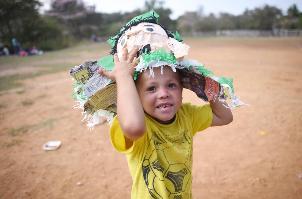 A Central American child taking part in a caravan called “Migrant Viacrucis”, plays at a sports center field in Matias Romero, Oaxaca state, Mexico, on Monday. — AFP