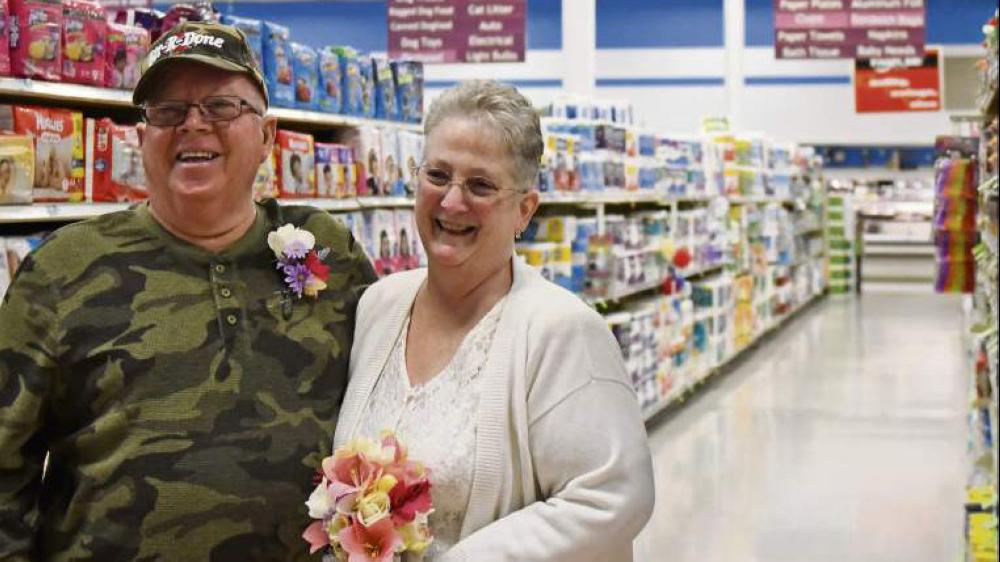 Larry Spiering and Becky Smith pose after their wedding at the Community Supermarket in Lower Burrell, Pennsylvania on Sunday. - AP