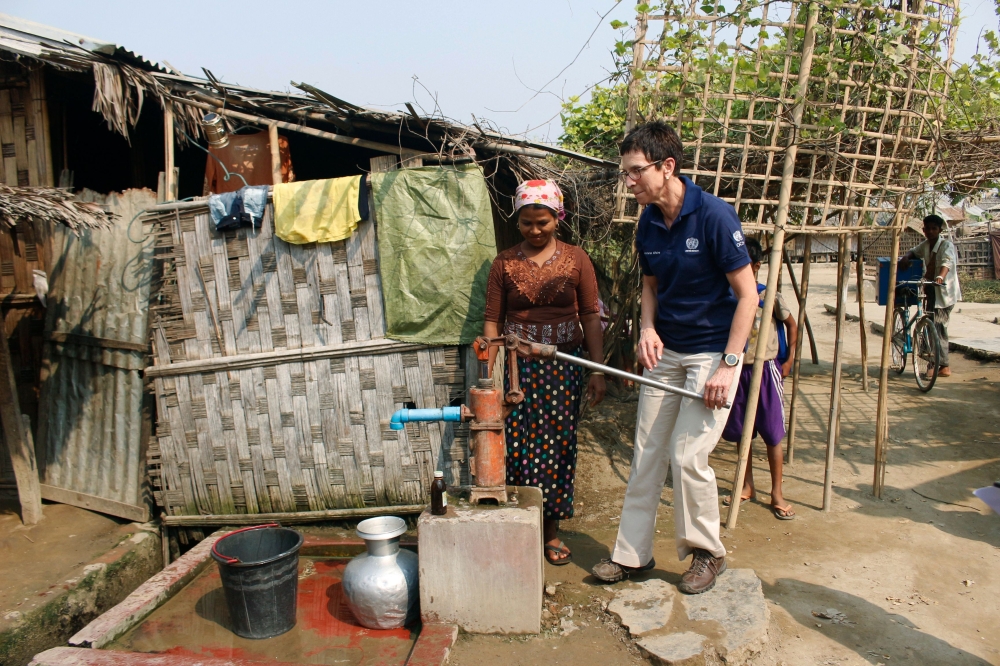 The United Nations Assistant Secretary General for Humanitarian Affairs and Deputy Emergency Relief Coordinator Ursula Mueller (R) try a hand water pump while meeting with members of the Muslim community in Sittwe, Rakhine State.  — AFP photos
