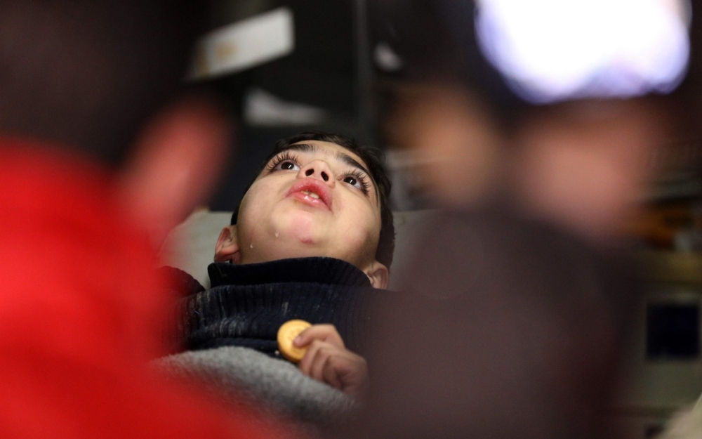 A Syrian boy is treated in an ambulance after being evacuated from Douma, Eastern Ghouta. — AFP photos

