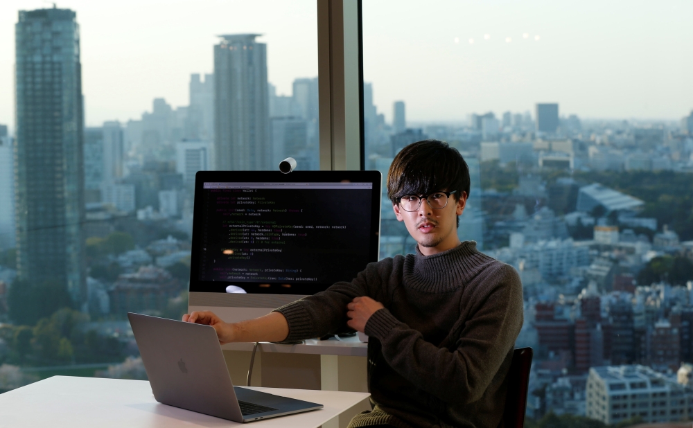Ryo Fukuda, a software engineer at Next Currency Inc, a company seeking to launch a cryptocurrency exchange, poses for a photo after an interview with Reuters at the company's headquarters in Tokyo, Japan. — Reuters