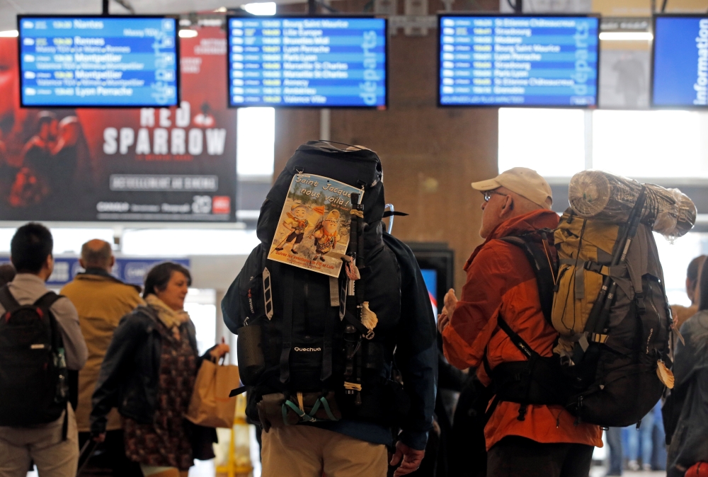 Passengers look at information boards at the Lyon Part-Dieu train station in Lyon, France, on Saturday. — Reuters