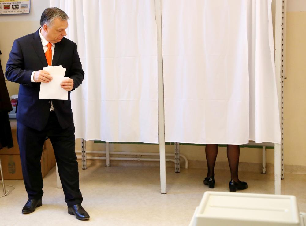 Hungarian Prime Minister Viktor Orban leaves a polling booth to cast his ballot during Hungarian parliamentary election in Budapest, Hungary, on Sunday. — Reuters