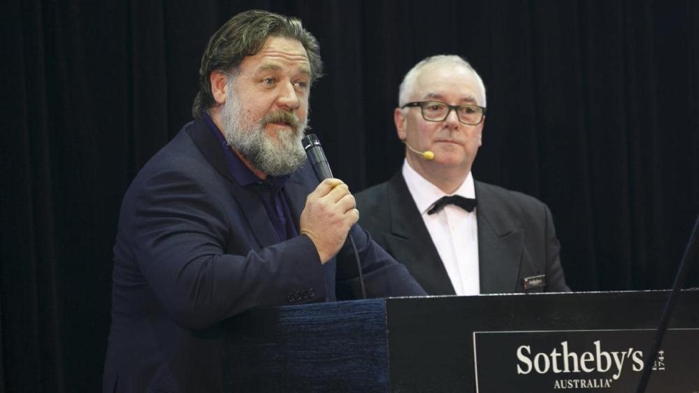 Actor Russell Crowe, left, with auctioneer Martin Gallon, at his 