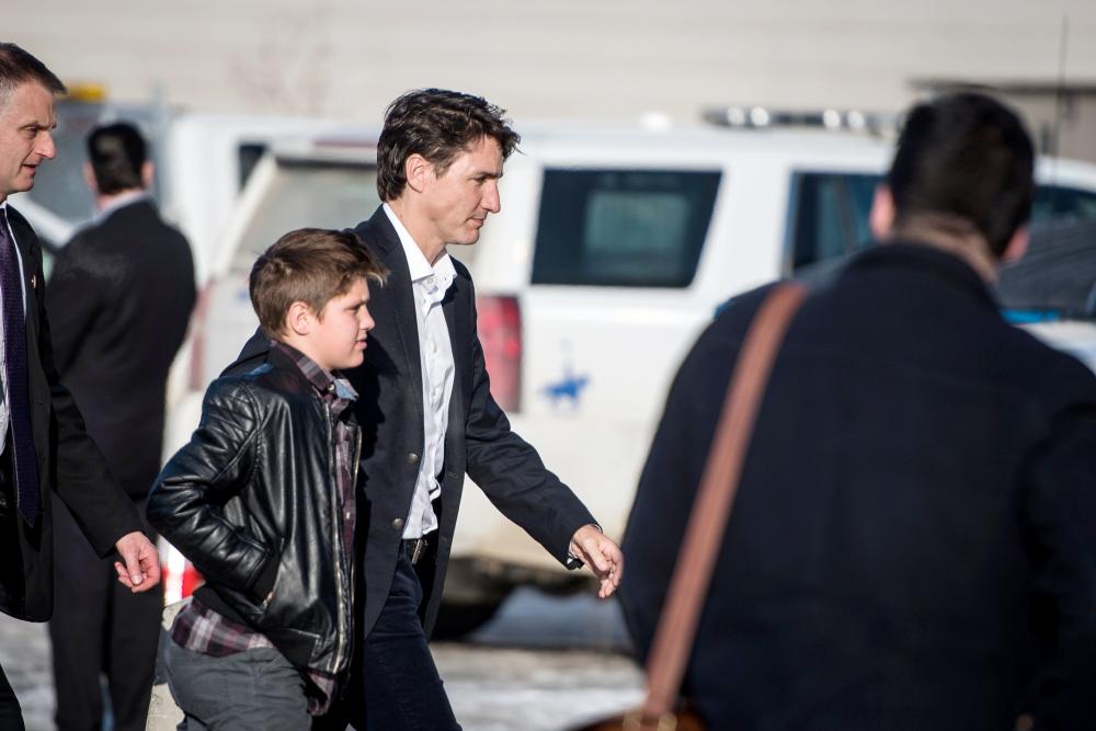 Canadian Prime Minister Justin Trudeau arrives with his son Xavier at the Elgar Petersen Arena to attend a vigil for members of the Humboldt Broncos in Humboldt, Saskatchewan, Canada, on Sunday. — Reuters