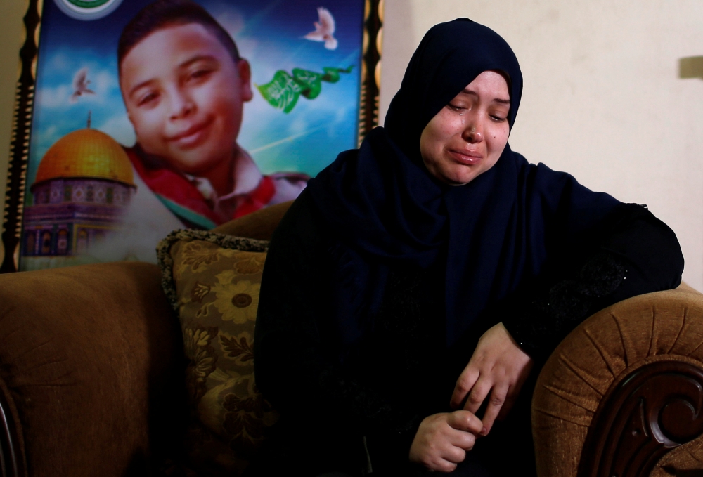 Eman, the mother of Palestinian boy, Hussein Madi, who was killed at the Israel-Gaza border, weeps during an interview at her house in Gaza City. — Reuters