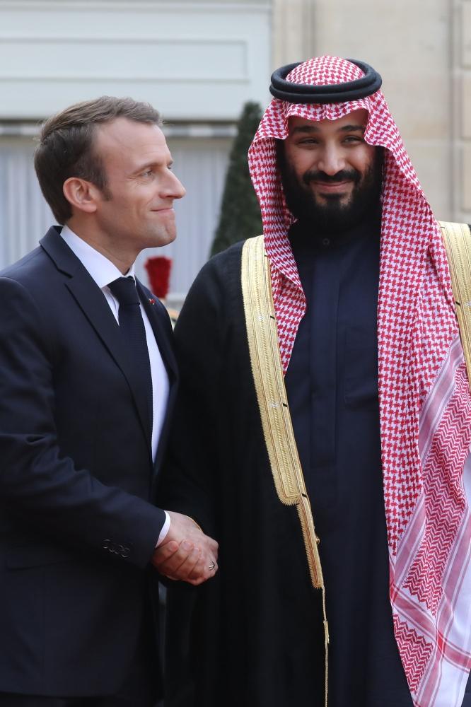 French President Emmanuel Macron (R) welcomes Saudi Arabia's Crown Prince Muhammad Bin Salman upon his arrival at the Elysee Presidential palace for a meeting on April 10, 2018 in Paris. — AFP