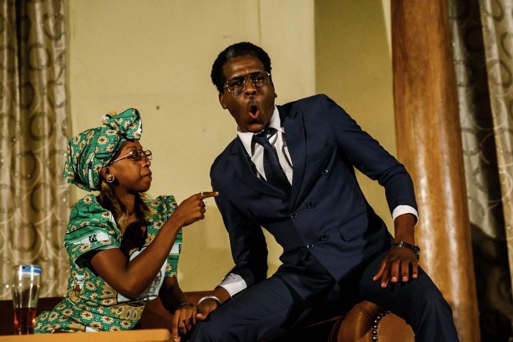 Theater actress Carol Magenga (left) interpreting Zimbabwe's former first lady Grace Mugabe and theater actor Khetani Banda (right) in the role of former Zimbabwe's president Robert Mugabe perform on stage during a satirical play called 