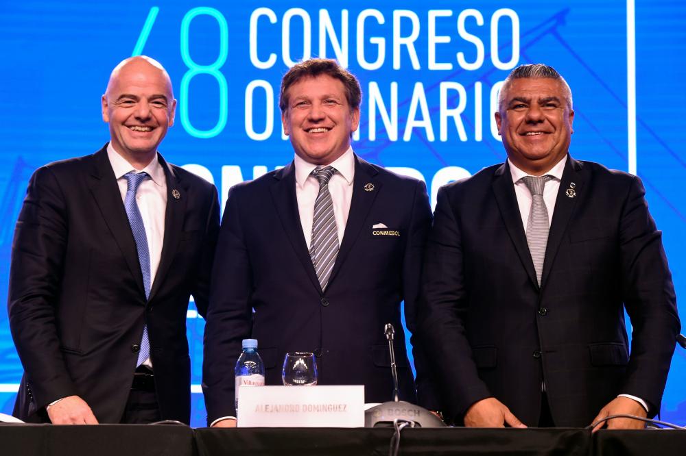 Conmebol President Alejandro Dominguez (C), FIFA President Gianni Infantino (L) and Argentinian Argentine Football Association President Claudio Tapia pose after a press confernce at the end of the 68th Conmebol Council meeting in Buenos Aires Friday. — AFP