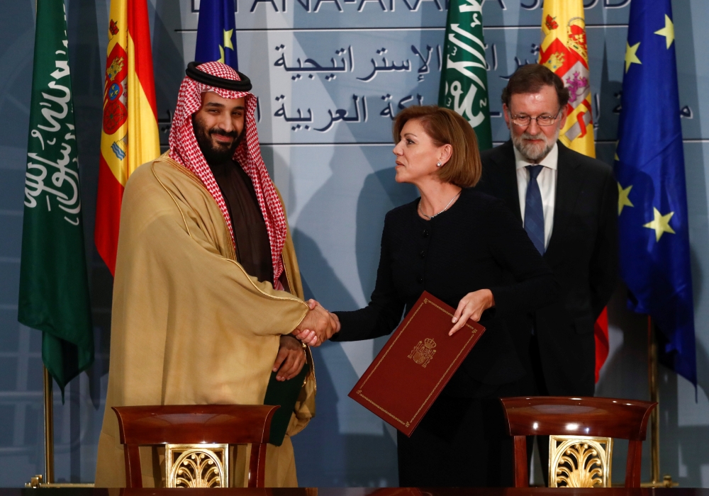 The Crown Prince shakes hands with Spain's Defense Minister Maria Dolores de Cospedal after signing a framework deal as Prime Minister Rajoy looks on at the Moncloa Palace in Madrid, Thursday. — Reuters