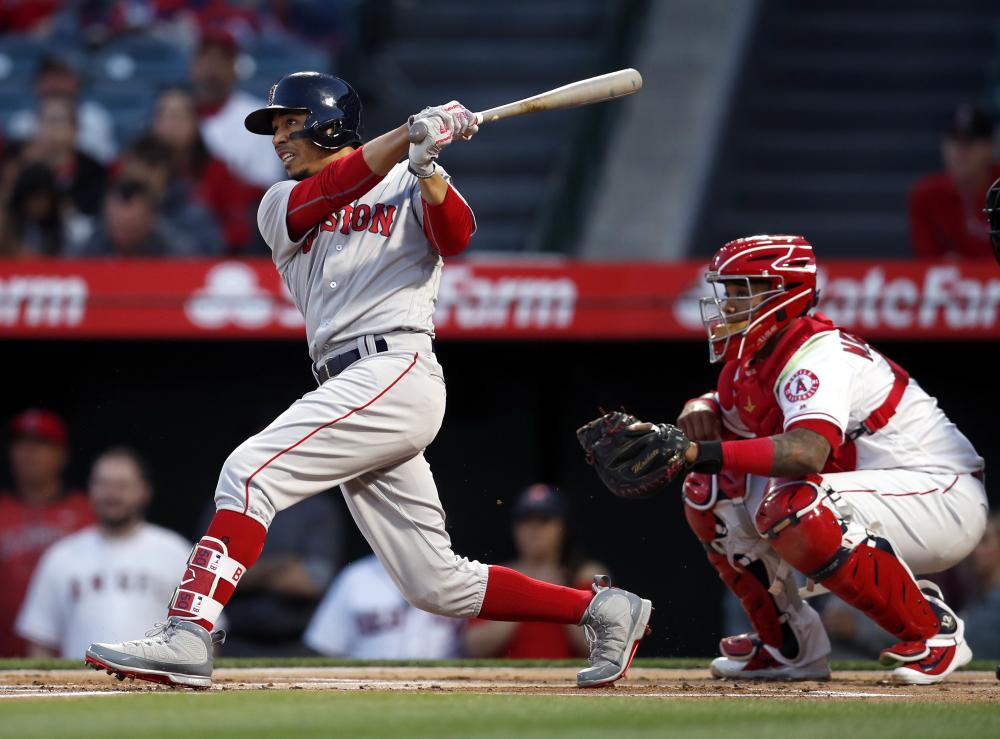 Boston Red Sox’s right fielder Mookie Betts connects for a solo home run against the Los Angeles Angels during their MLB game at Angel Stadium in Anaheim, California, Tuesday. — EPA