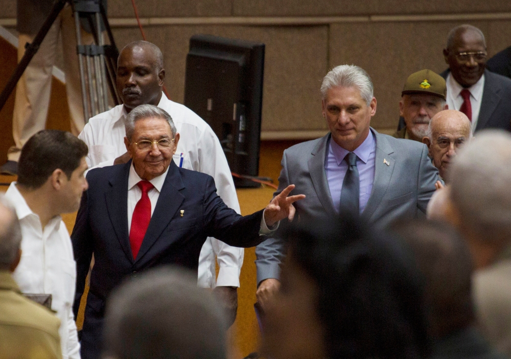 Raul Castro (center-left) and Miguel Diaz-Canel (center-right) arrive for a session of the National Assembly in Havana, Cuba, Wednesday. — Reuters