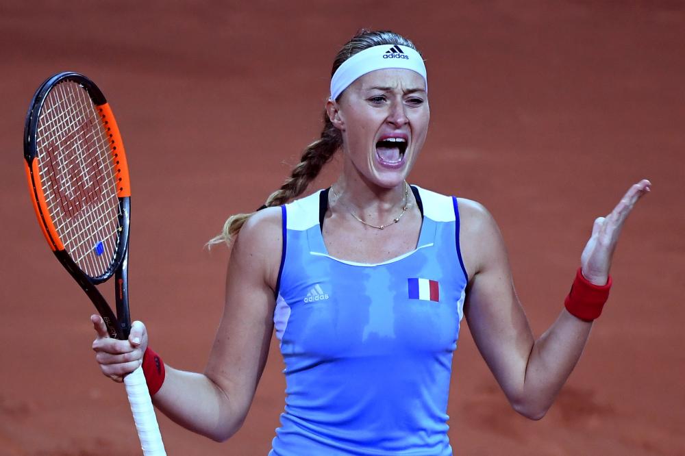 France's Kristina Mladenovic jubilates after her victory over CoCo Vandeweghe of the US in the Fed Cup semifinal at the Arena Stadium in Aix en Provence Saturday. — AFP