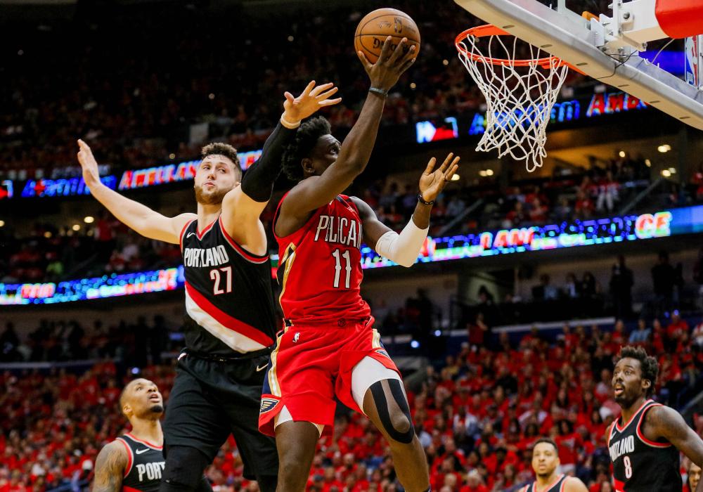 New Orleans Pelicans’ guard Jrue Holiday leaps to the basket past Portland Trail Blazers’ center Jusuf Nurkic during Game 4 of the NBA playoffs at the Smoothie King Center in New Orleans Saturday. — Reuters