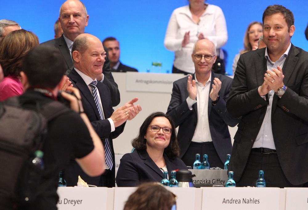 Parliamentary group leader of the Social Democratic Party (SPD) Andrea Nahles, center, is applauded by German Finance Minister and Vice Chancellor Olaf Scholz, left, and general secretary of the Social Democratic Party (SPD) Lars Klingbeil, right, after being elected as chairwoman of the German Social Democratic Party SPD during a party rally in Wiesbaden, Germany, on Sunday. — AFP