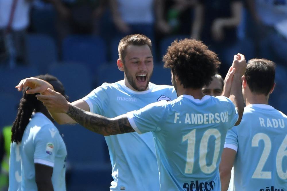 Lazio's defender Stefan de Vrij (L) celebrates with midfielder Felipe Anderson after scoring a goal during the Italian Serie A football match against Sampdoria at Rome's Olympic Stadium Sunday. — AFP 