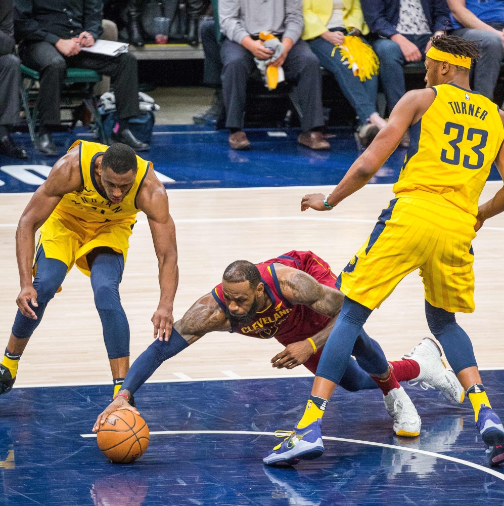 Cleveland Cavaliers forward LeBron James (23) dives for a loose ball in front of Indiana Pacers forward Thaddeus Young (21) and center Myles Turner (33) in the second half of game four in the first round of the 2018 NBA Playoffs at Bankers Life Fieldhouse. — Reuters