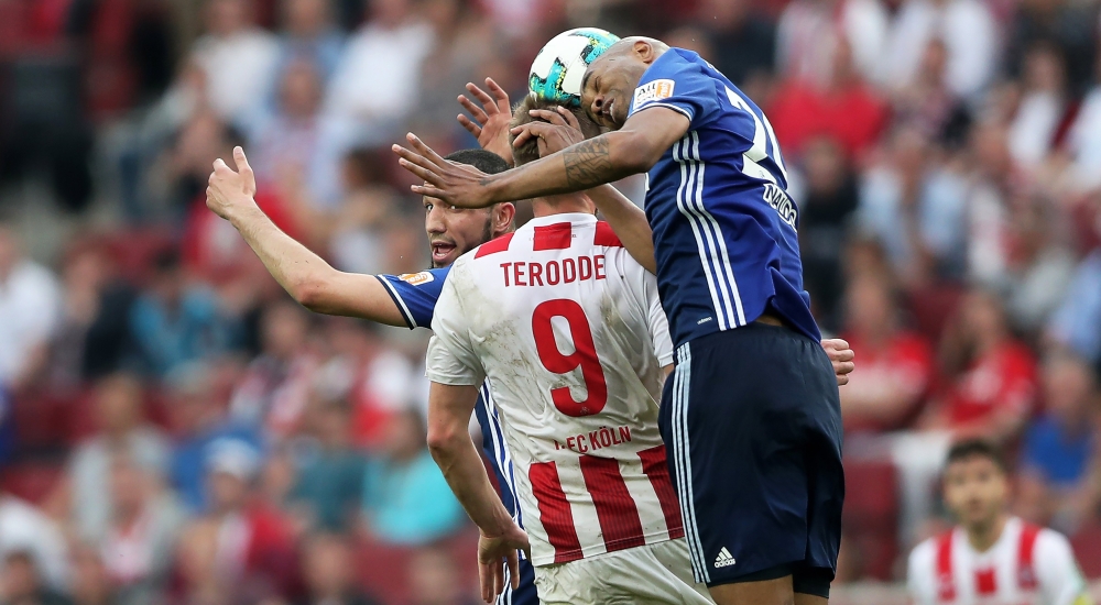 Cologne's Simon Terodde (C) in action against Schalke players Nabil Bentaleb (L) and Naldo (R) during the German Bundesliga soccer match in Cologne, Germany, on Sunday. — EPA