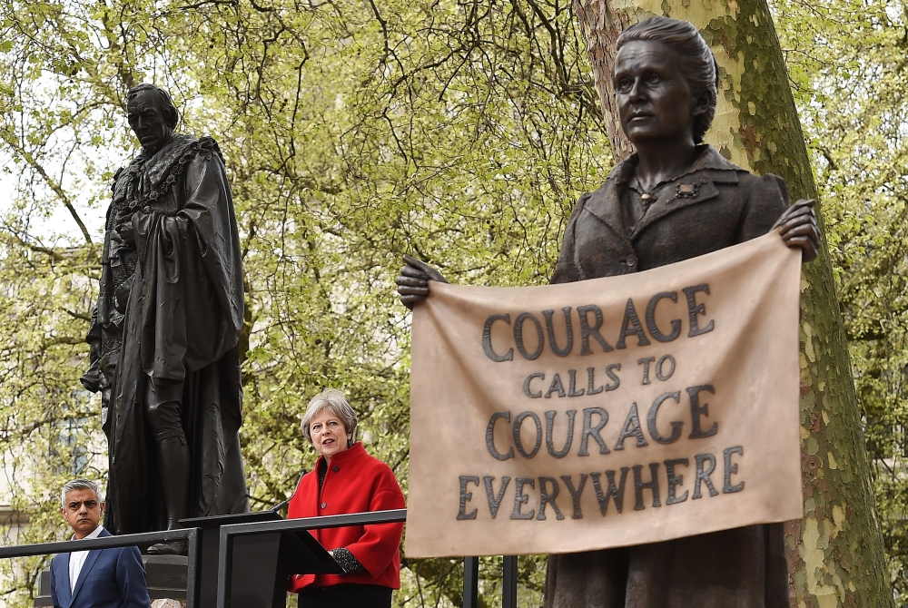 London Mayor, Sadiq Khan, left, look on as British Prime Minister Theresa  May unveils the statue of suffragist leader Millicent Fawcett in Parliament Square in London, Britain, on Tuesday. — EPA