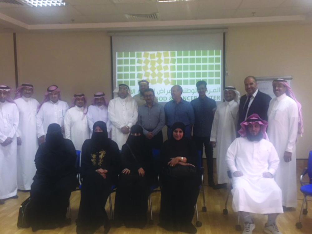 President of Nozaf Dr Mohammed Alshahrani, vice president of Nozaf Dr. Tarek Owaidah, Francois Meurgey, Senior Associate at Management Centre Europe (MCE); Roche Products Saudi Arabia General  Manager Dr. Mohamed Elghareeb pose for a group photo with some resource persons and participants in a workshop

