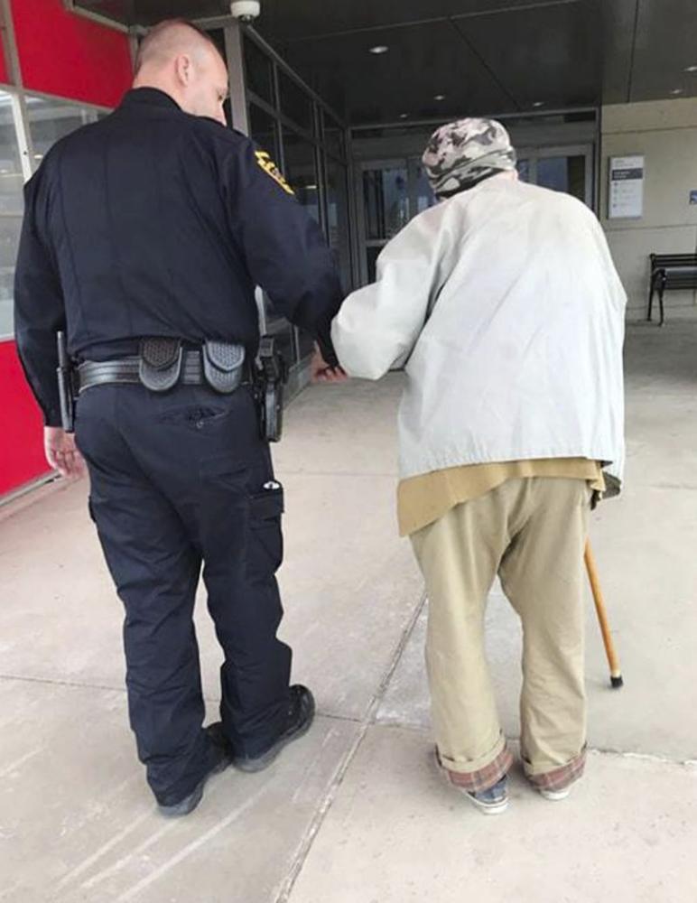 In this photo provided by the Montoursville Police Department, Jason Bentley, left, deputy chief of the department, escorts an 84-year-old man to see his wife, also 84, in the emergency department of UPMC Susquehanna hospital in Williamsport, Pennsylvania. - AP
