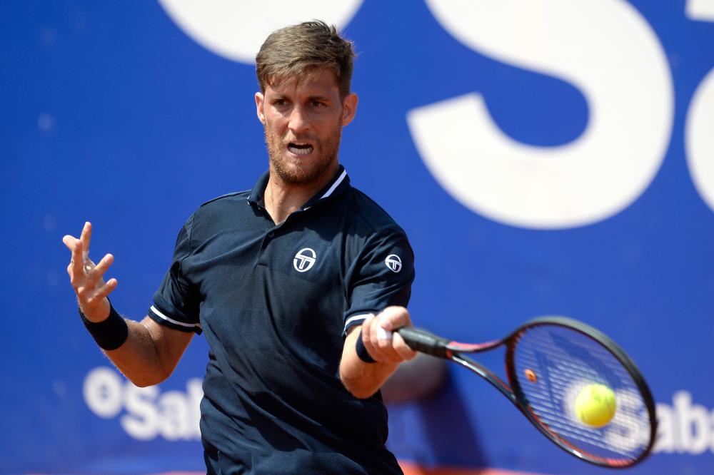 Slovakia’s Martin Klizan returns the ball to Serbia’s Novak Djokovic during their Barcelona Open ATP Tournament match in Barcelona Wednesday. — AFP 