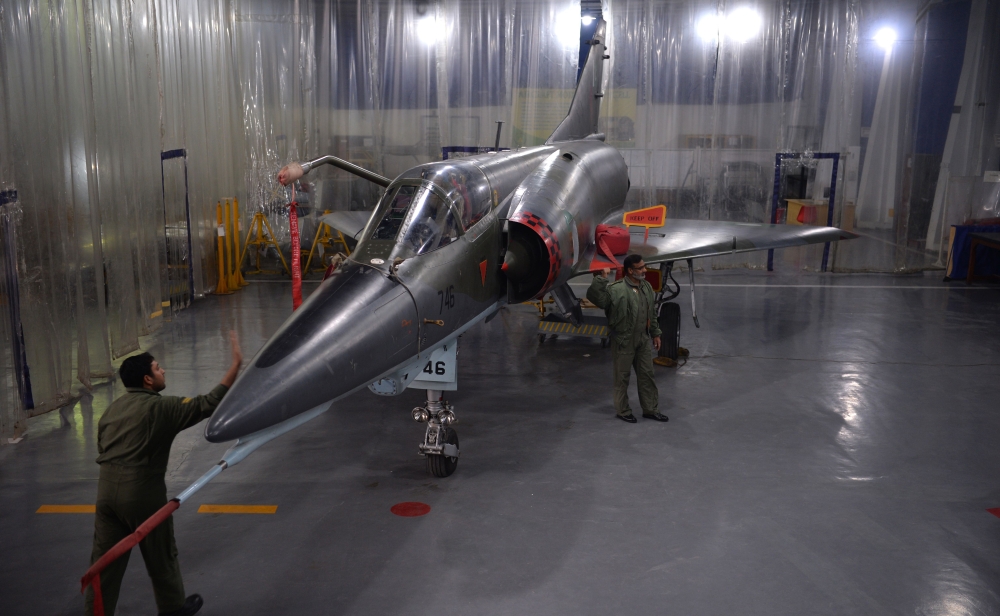 Technicians inspect a Mirage aircraft after the installation of air-to-air refueling probe as it undergoes an overhaul by the Pakistan Air Force (PAF) at the Mirage Rebuild Factory (MRF) in Kamra, west of the capital Islamabad, in this Dec. 27, 2017 file photo. — AFP