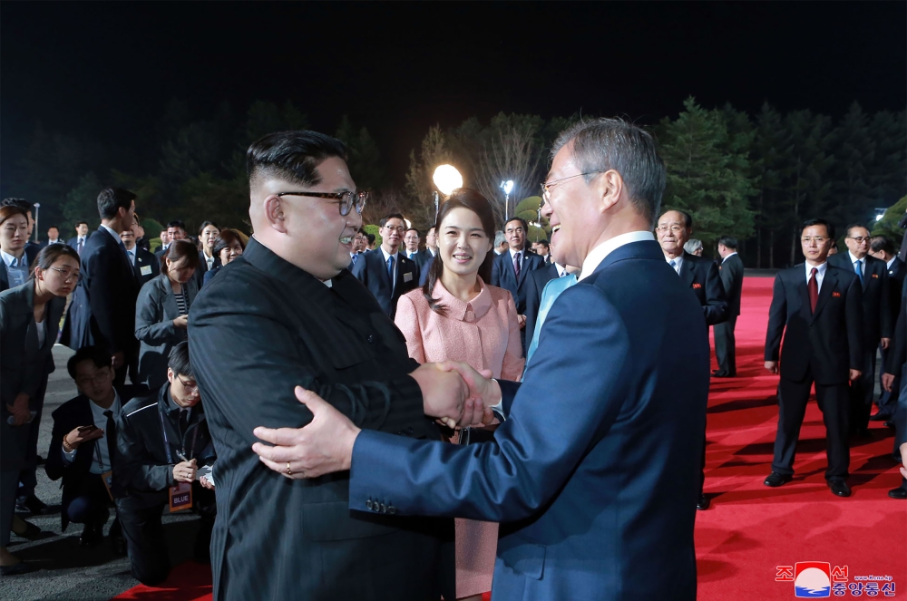 This picture taken on Friday and released on Sunday shows North Korea’s leader Kim Jong Un, left, and South Korea’s President Moon Jae-in, right, bidding farewell during a closing ceremony of the inter-Korean summit in the truce village of Panmunjom. — AFP