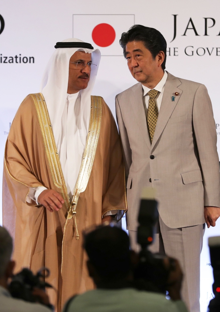 Japan's Prime Minister Shinzo Abe (R) and UAE's Minister of Economy Sultan Bin Saeed Al-Mansoori attend a Japan-UAE Business Forum in Abu Dhabi on Monday. — AFP