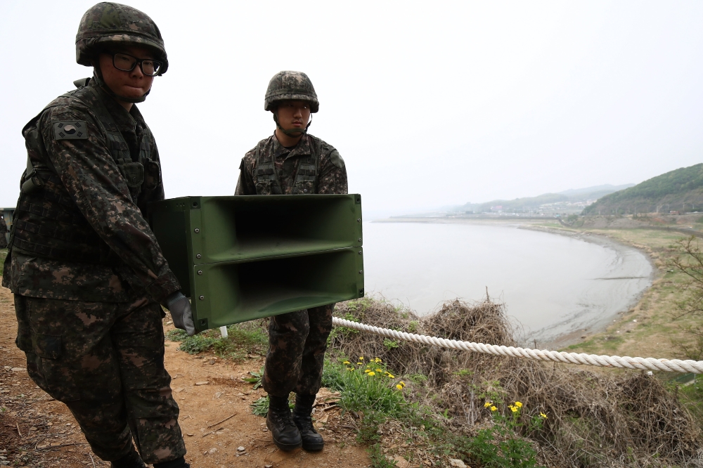 South Korean soldiers take down a propaganda loudspeaker on the border with North Korea in Paju, South Korea, on Tuesday. — EPA