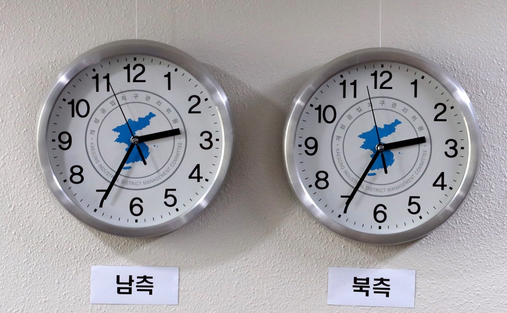A pair of clocks hanging on a wall at the office of the Kaesong Industrial District Foundation in Seoul show the same time in South Korea, left, and North Korea, on Tuesday. — EPA