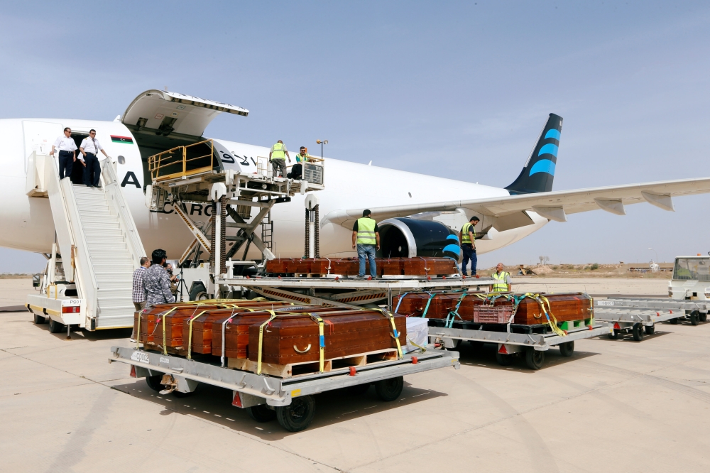 The remains of the bodies of Egyptian Copts killed by Daesh militants in Sirte are loaded to the plane to be transferred to Egypt, in Misrata, Libya. — Reuters