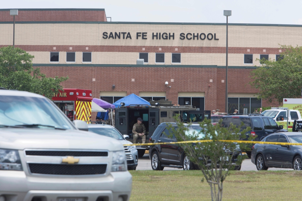 Emergency crews gather in the parking lot of Santa Fe High School where at least eight students were killed on Friday in Santa Fe, Texas.  — AFP