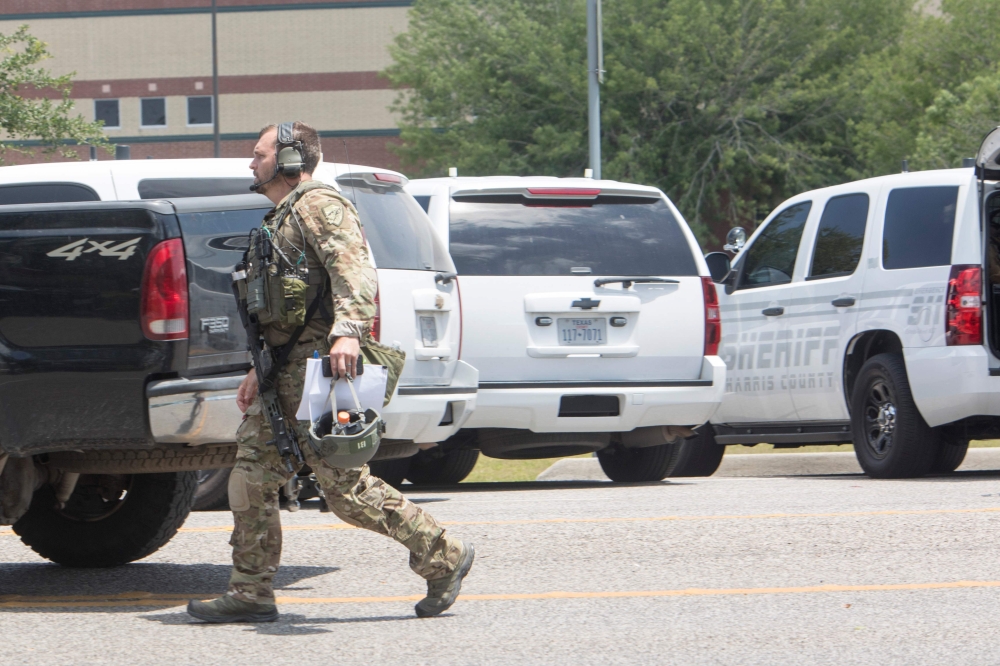 Emergency crews gather in the parking lot of Santa Fe High School where at least eight students were killed on Friday in Santa Fe, Texas.  — AFP