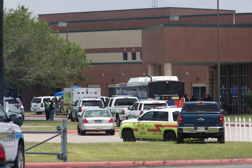 Emergency crews gather in the parking lot of Santa Fe High School where at least eight people were killed on Friday in Santa Fe, Texas. — AFP