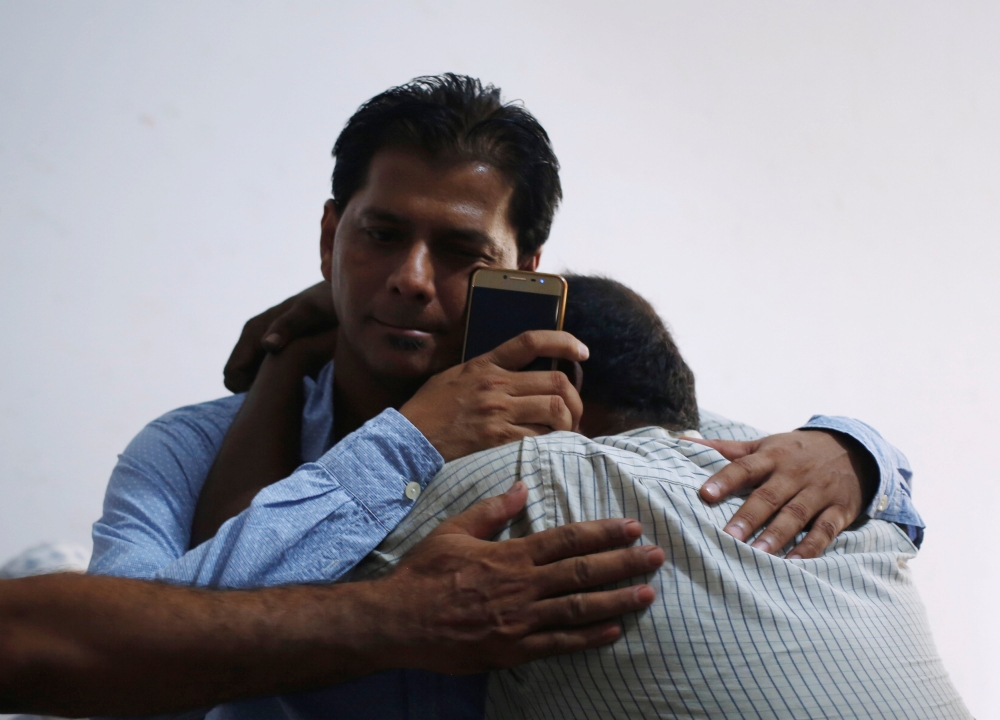 Aziz Shaikh, left, father of Sabika Aziz Sheikh, a Pakistani exchange student, who was killed with others when a gunman attacked Santa Fe High School in Santa Fe, Texas, is comforted by a relative at his residence in Karachi, Pakistan, on Saturday. — Reuters