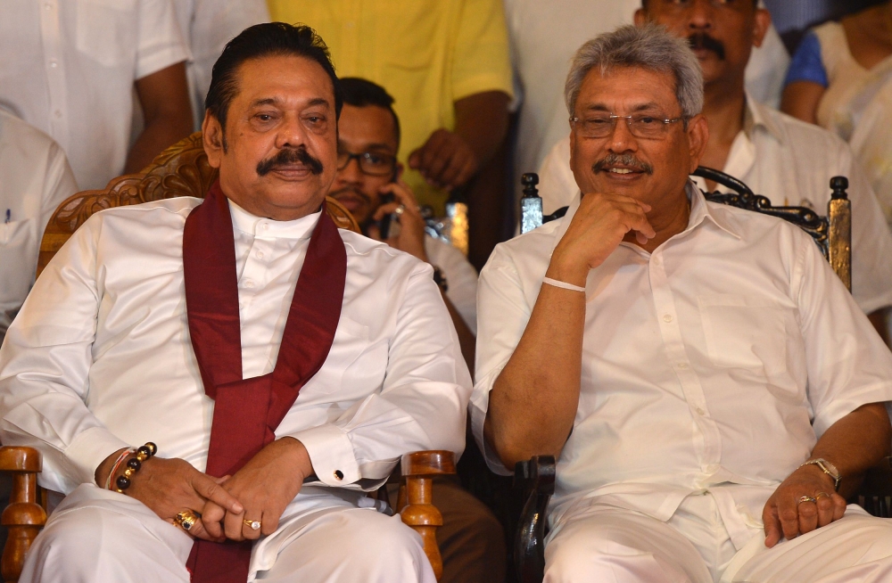 Former Sri Lankan President Mahinda Rajapaksa, left, and his brother, former Sri Lankan Defense Ministry Secretary Gotabaya Rajapaksa take part in a ceremony in Colombo on Saturday, held to mark the ninth anniversary of the end of Sri Lanka’s Tamil separatist war. — AFP